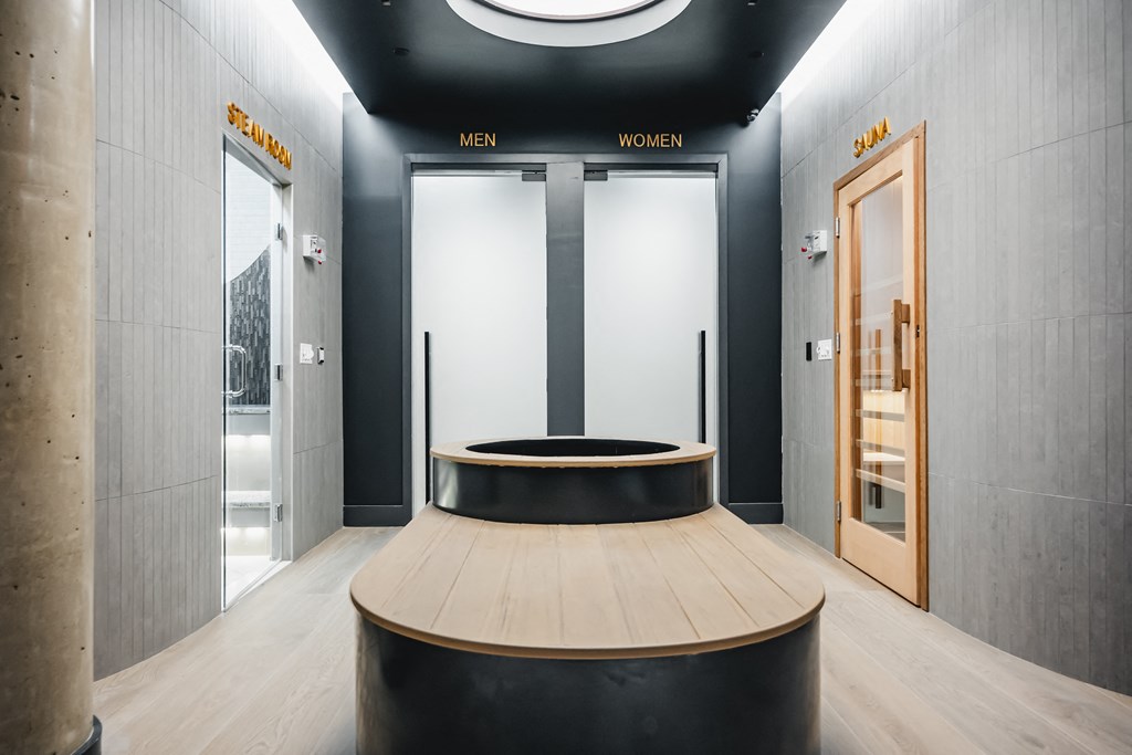 a circular seating area in the lobby of a building with two doors